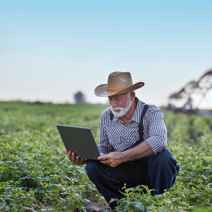 man with  computer in field